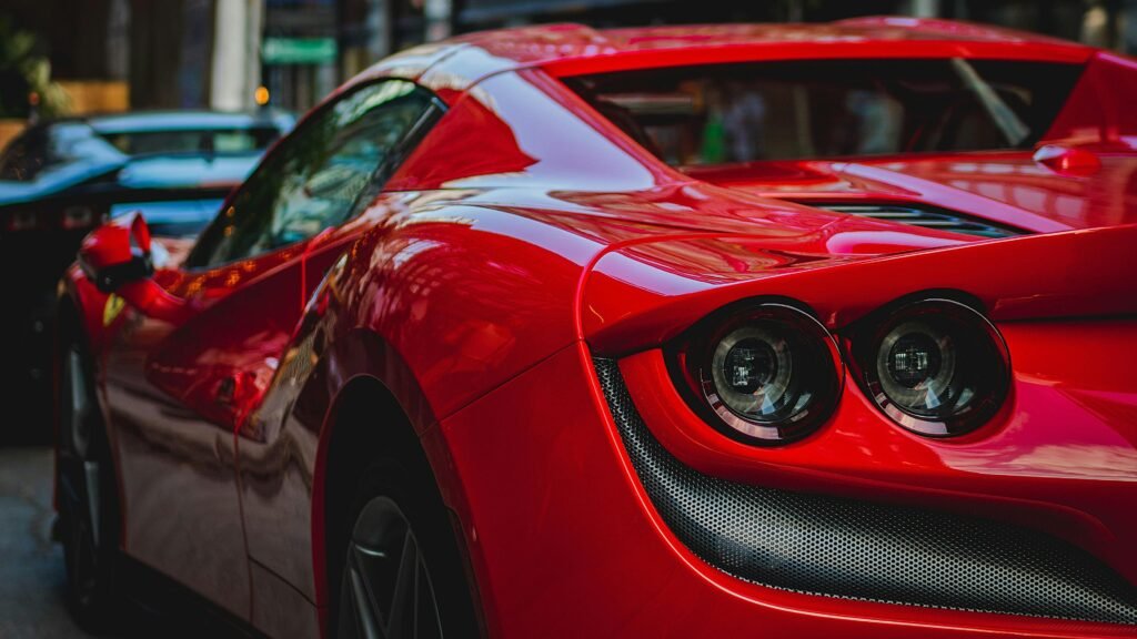 pexels-photo-17377918-17377918 Close-up shot of a luxurious red sports car showcasing its sleek design and shiny surface.